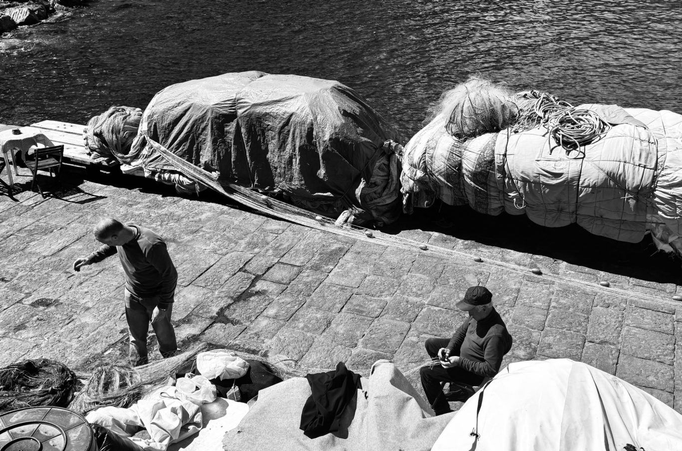Fishermen tending their nets, Italy